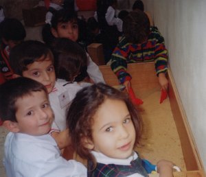 The children play in the sand in a safe environment.